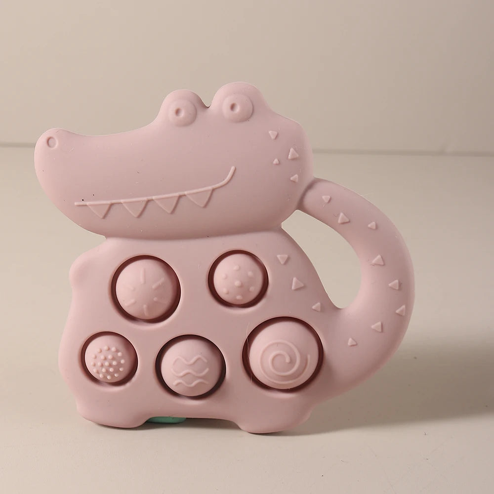 Pink alligator-shaped toy with textured surface on a beige background