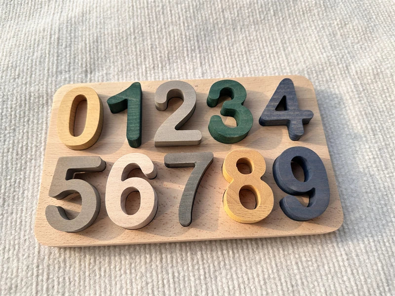 Set of wooden numbers on a light wooden board against a textured beige background