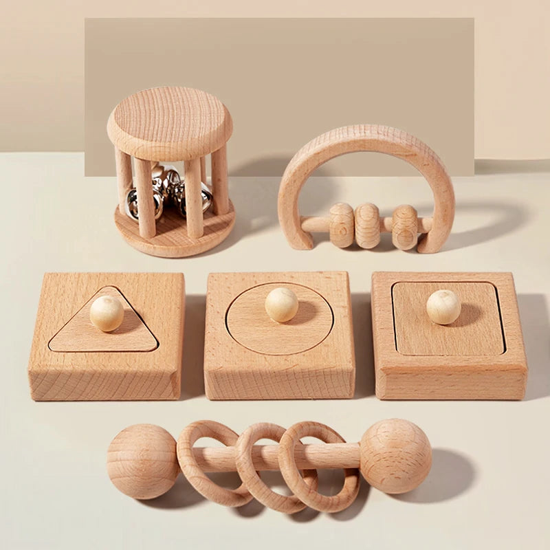 Set of wooden baby toys on a neutral background