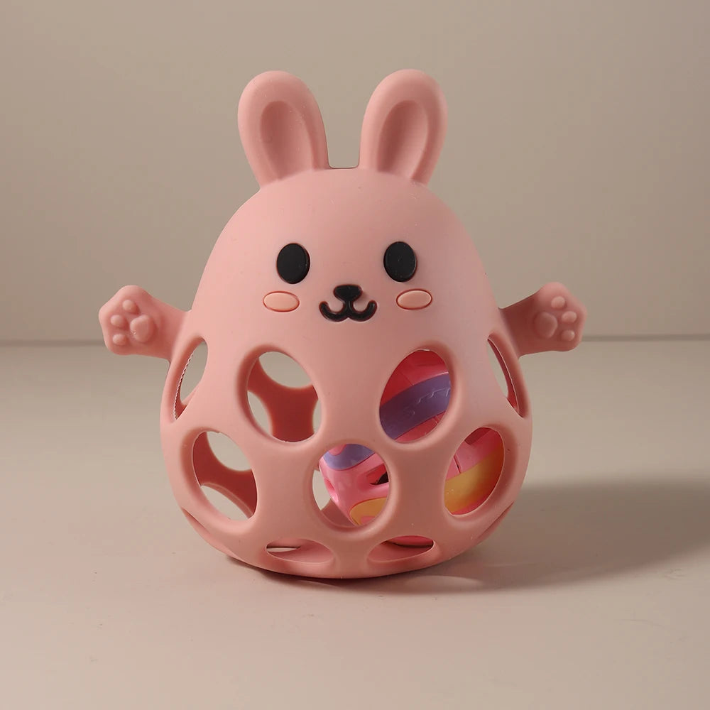 Pink bunny-shaped toy with a colorful interior on a beige background
