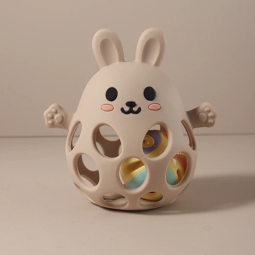 Cute rabbit-shaped toy with colorful interior on a beige background