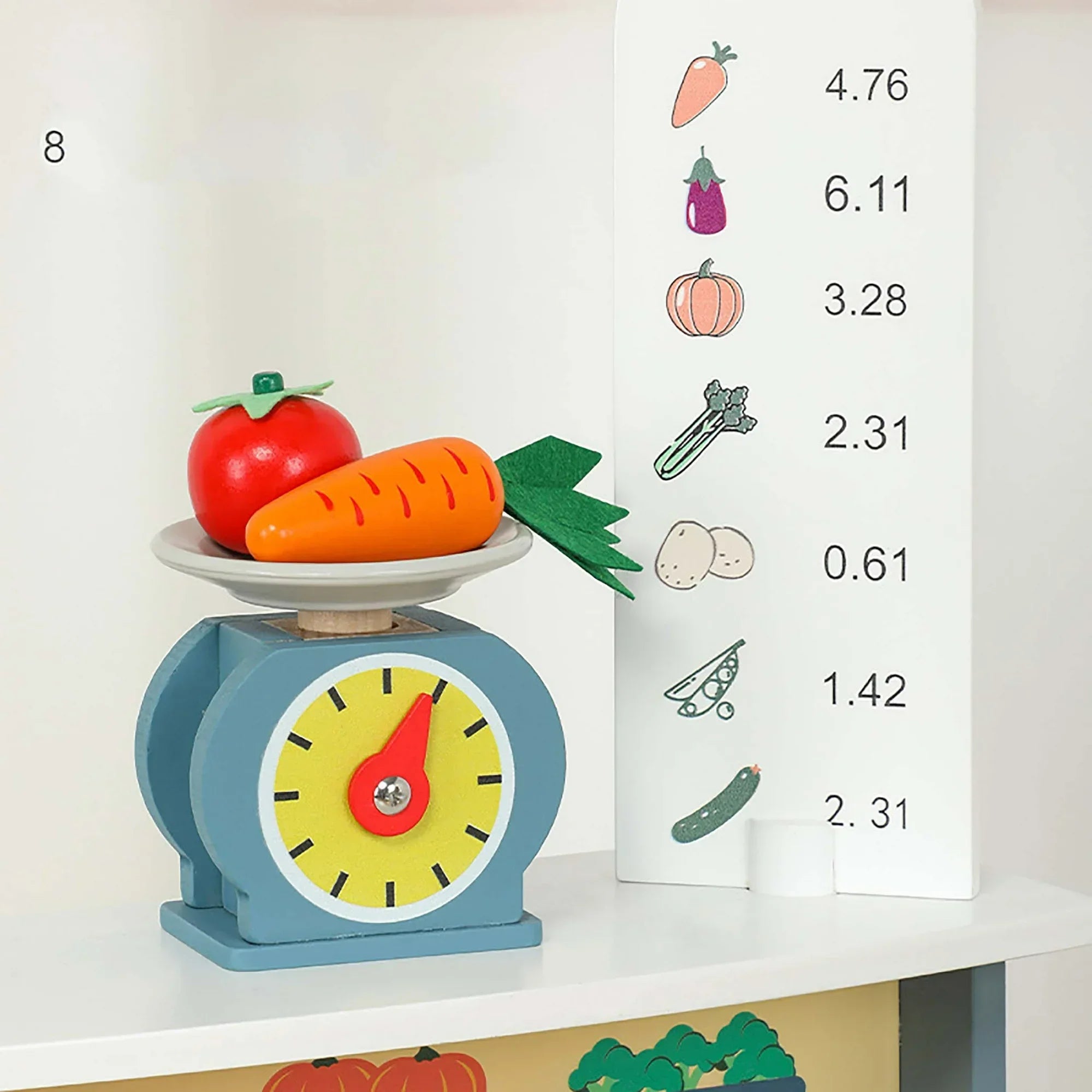 Toy scale with fruits and vegetables on a white surface, with a chart of vegetable weights in the background.