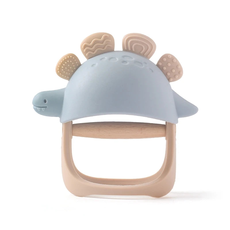 Baby teether shaped like a dinosaur with blue head and beige body on a white background