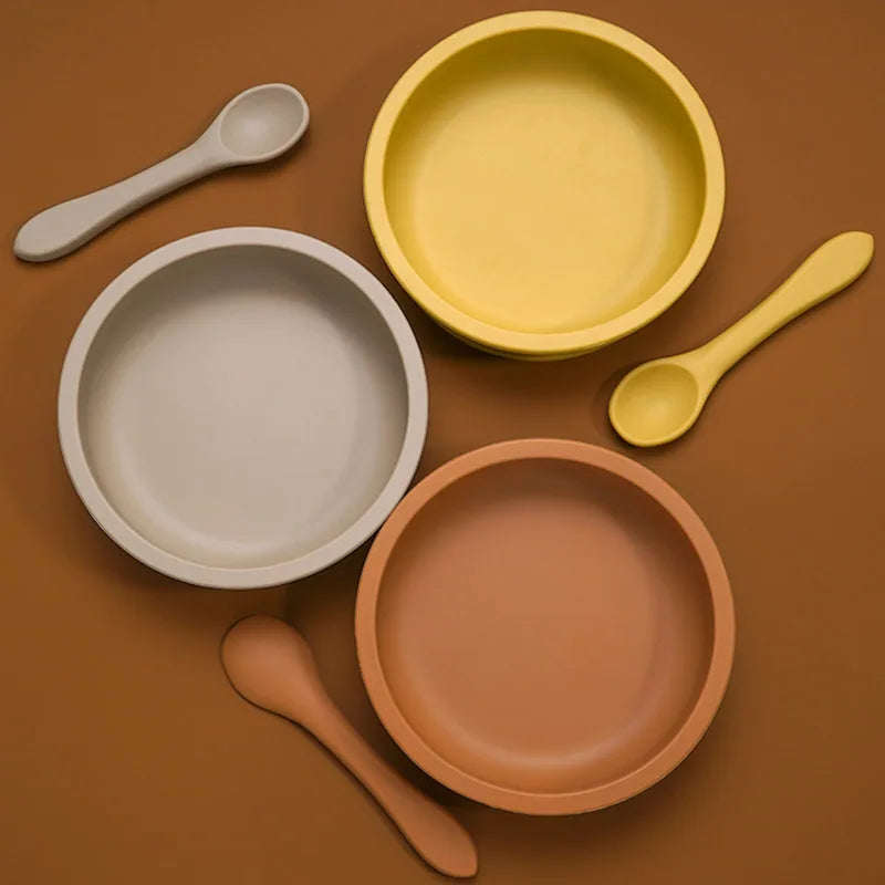 Wide silicone suction bowls with matching spoons from above