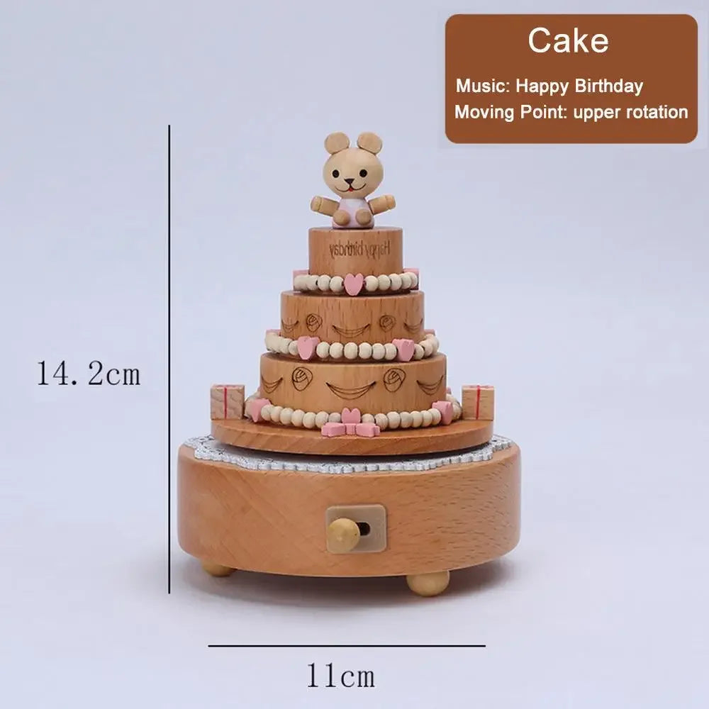 Wooden cake-shaped music box with a teddy bear on top, playing 'Happy Birthday', on a light gray background. | Oliver & Company Montessori Toys