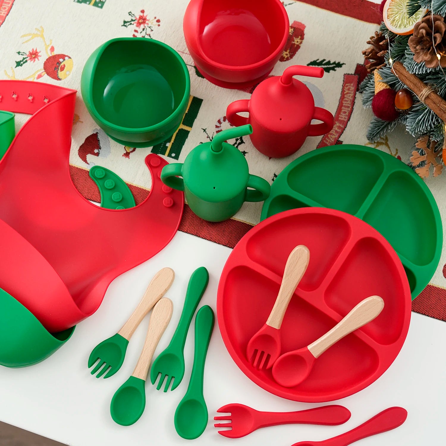 Red and green silicone feeding sets on a Christmas table