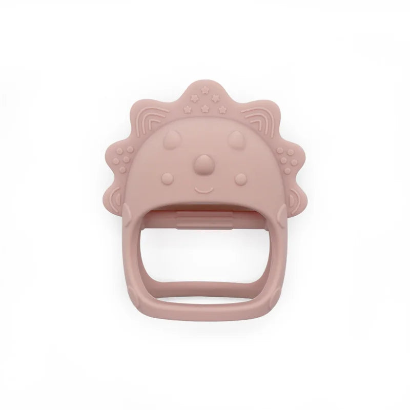 Pink silicone teether with a dinosaur design on a white background