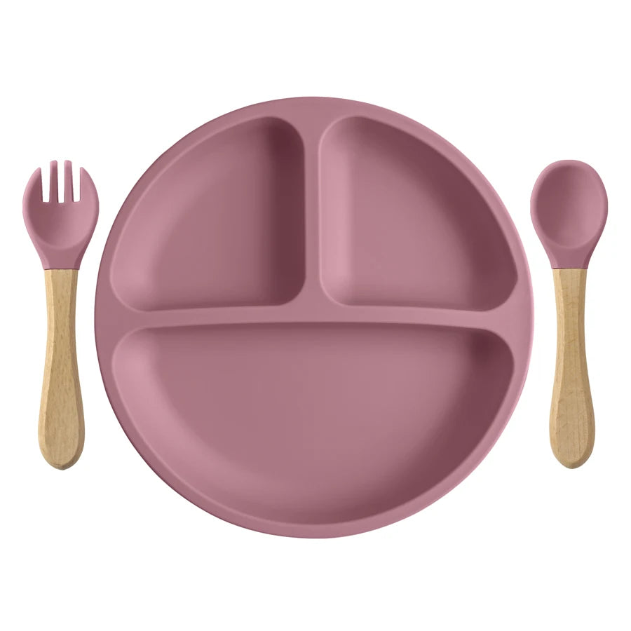 Mauve round divided plate with wooden spoon and fork