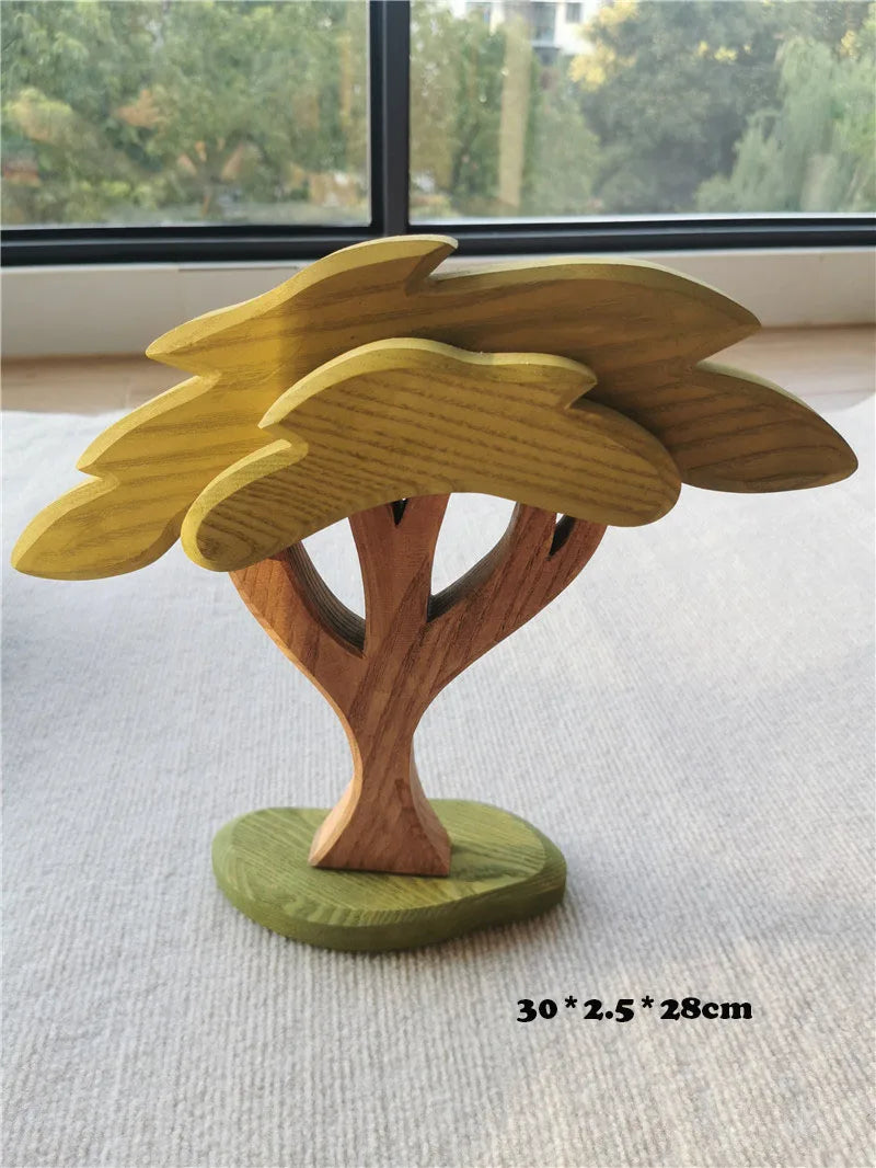 Wooden tree-shaped object on a flat surface with a blurred outdoor background