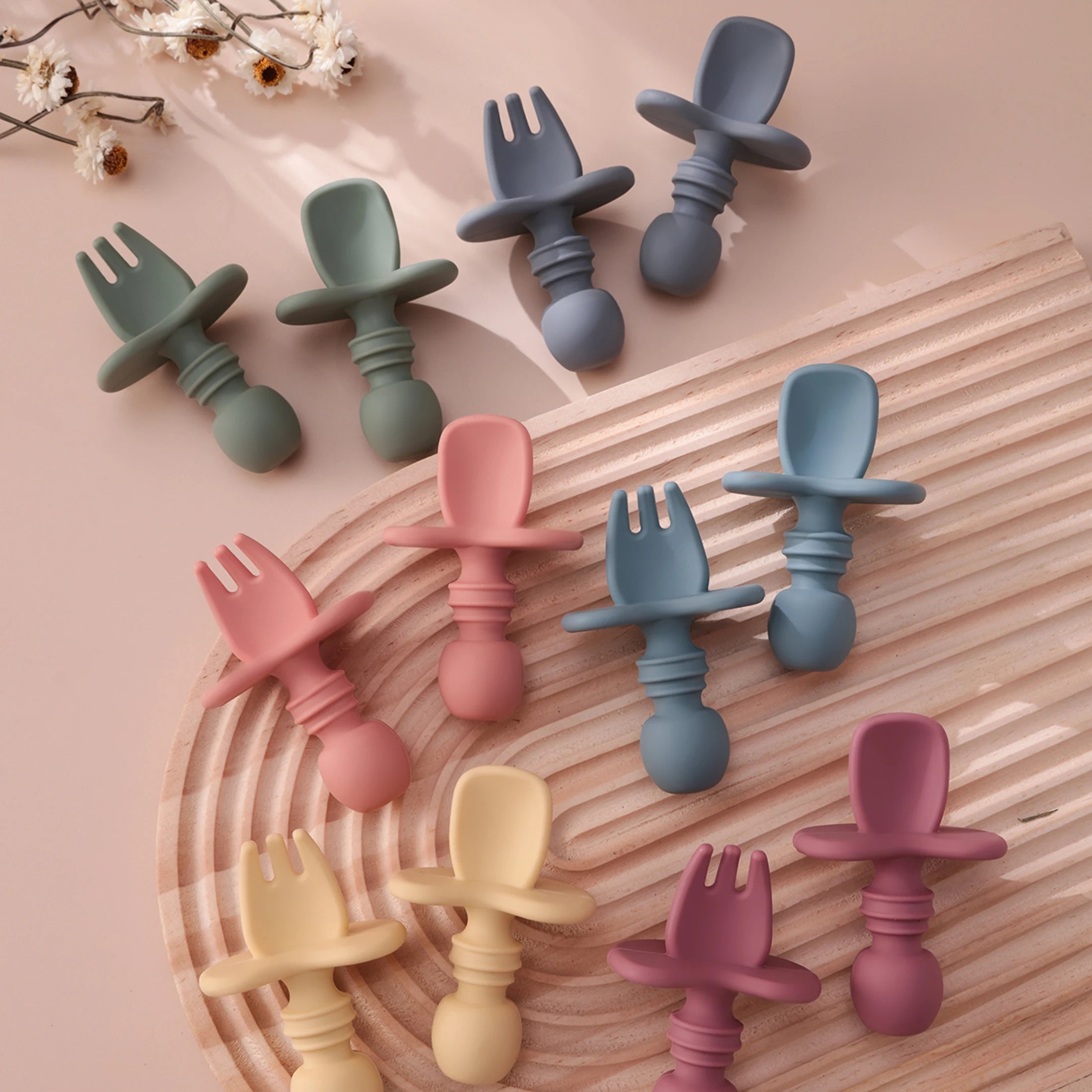 Choke guard spoons and forks spread across a wooden board