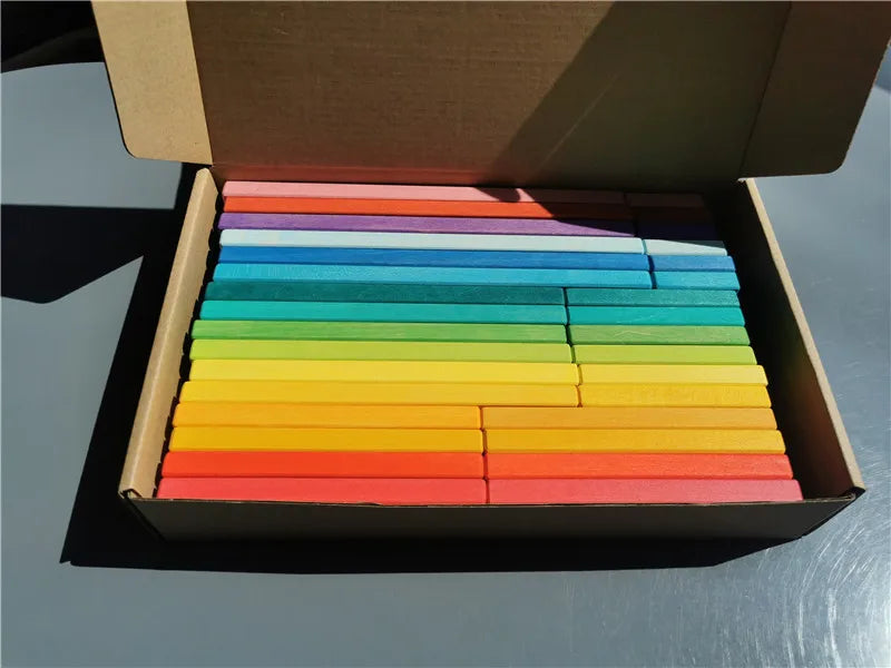 Box of colorful wooden blocks on a gray surface