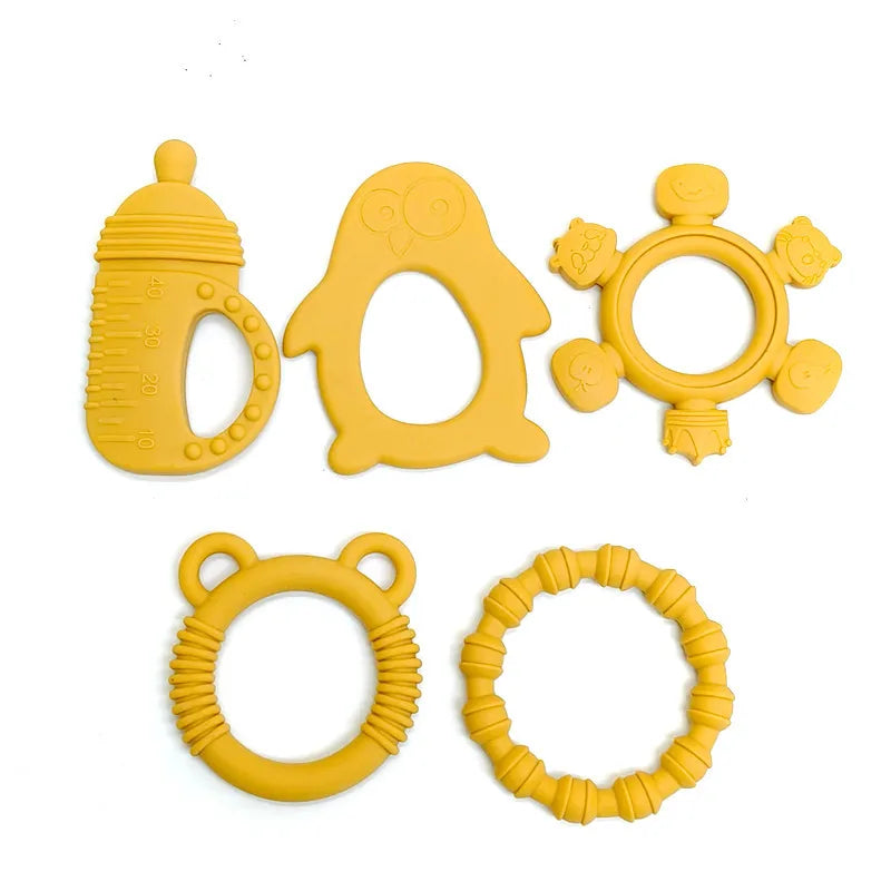 Six yellow silicone baby teething toys in different shapes, including a bottle, owl, sun, and bear designs, arranged on a plain white background.