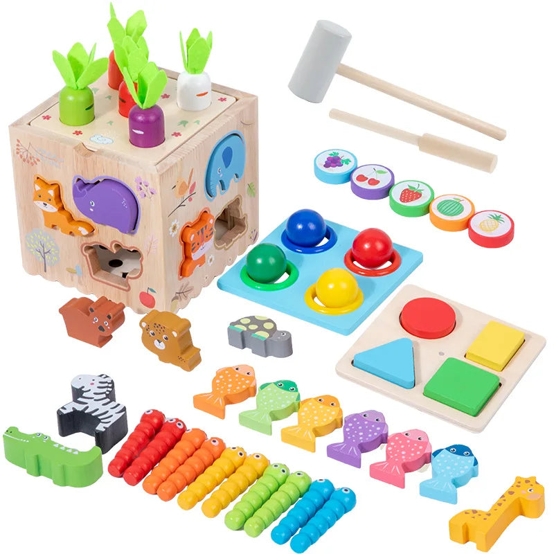 Set of wooden toys including a shape sorter, hammer, and various educational pieces on a white background.