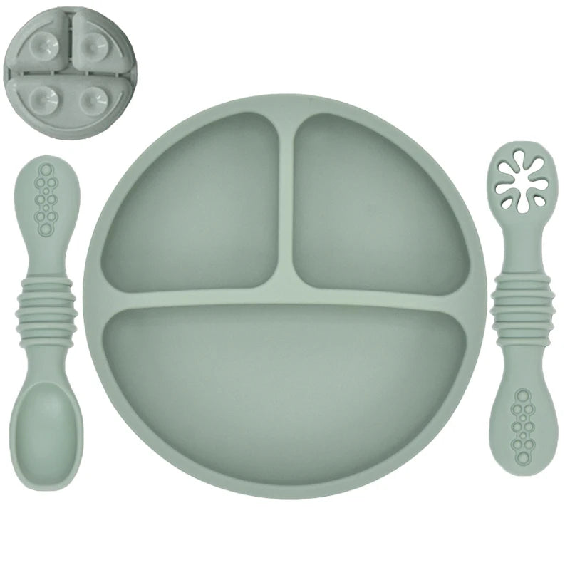 Silicone dining set with plate, spoon, and fork on a white background