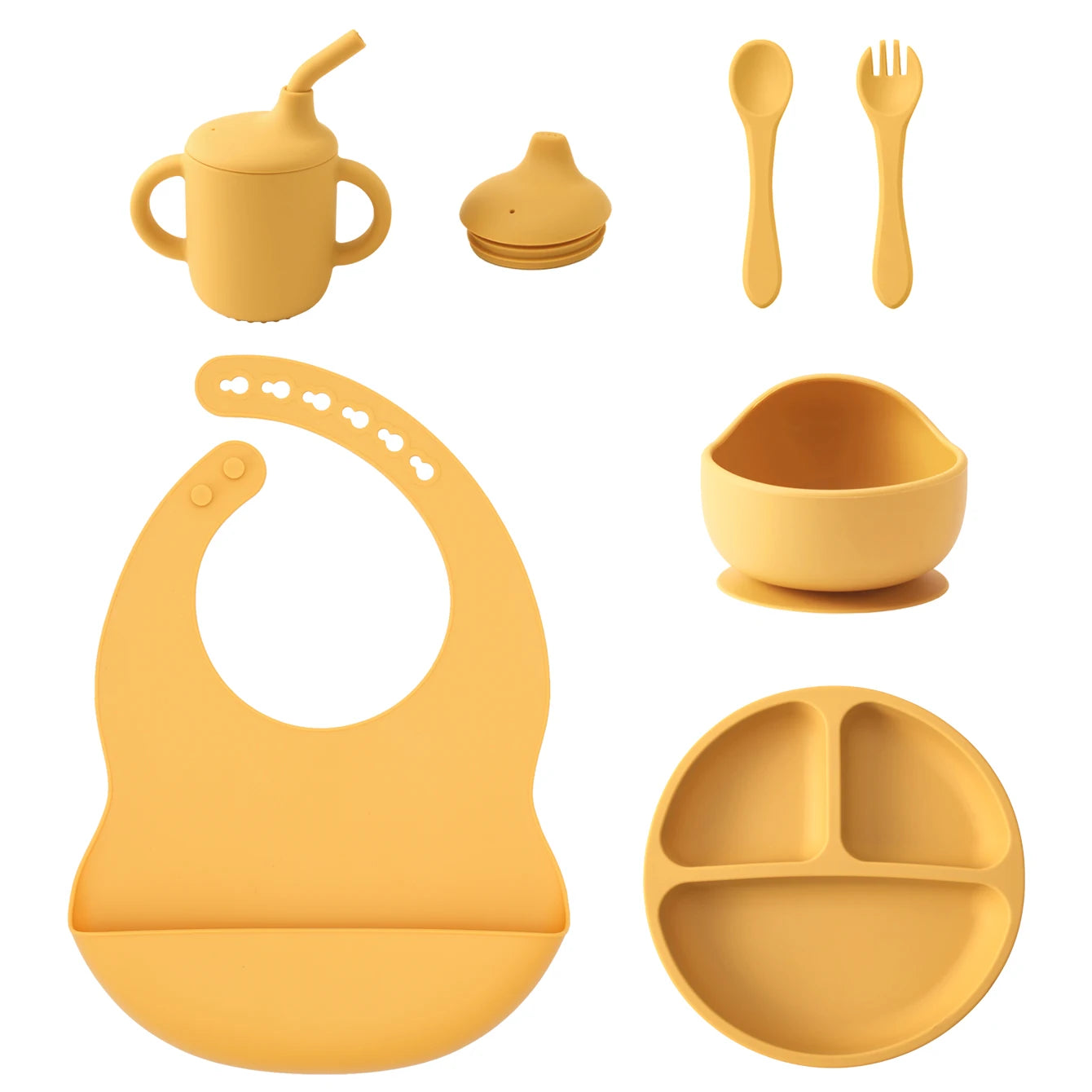 A set of yellow silicone baby feeding accessories on a white background, including a sippy cup with straw, a small bottle cap, a spoon, a fork, a suction bowl, a silicone bib, and a divided plate.