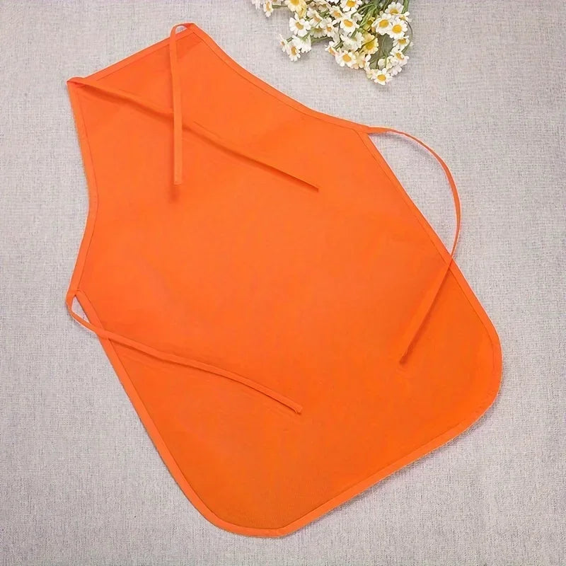 Orange apron on a gray surface with white flowers in the corner