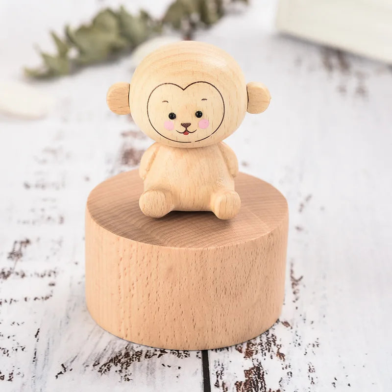 Wooden toy monkey on a round wooden base with a white background | Oliver & Company Montessori toys