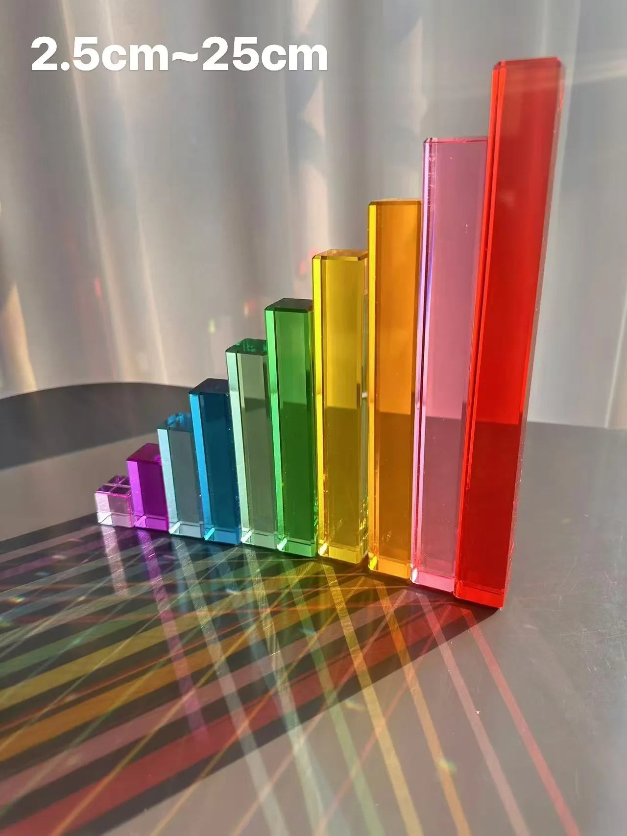 Set of colorful transparent acrylic blocks on a reflective surface with measurement text.