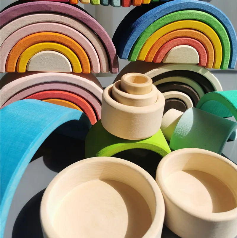Colorful wooden rainbow toys on a gray background
