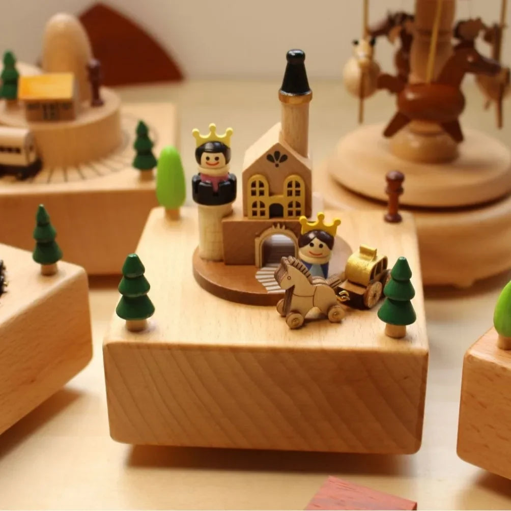 Wooden toy set with buildings, trees, and figures on a wooden base.