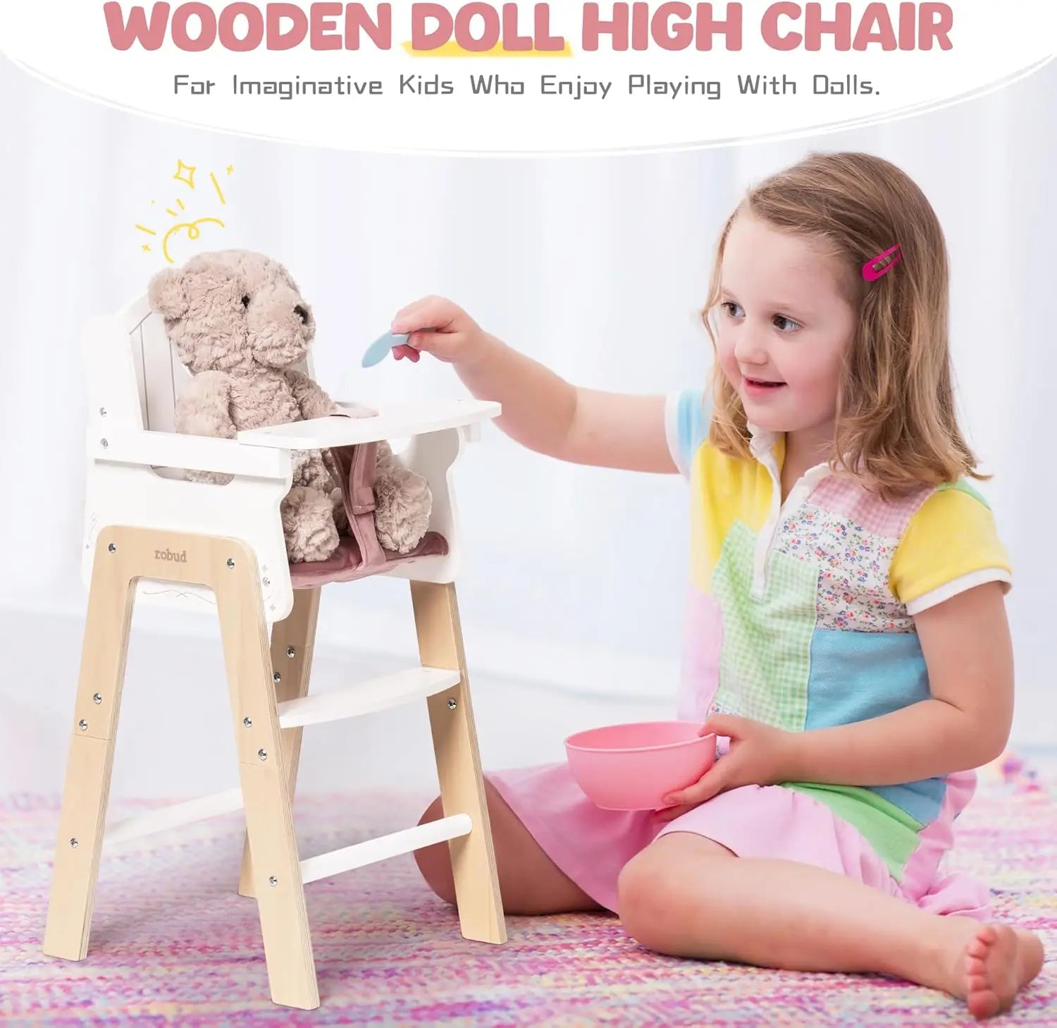 Child playing with a wooden doll high chair and teddy bear on a white background
