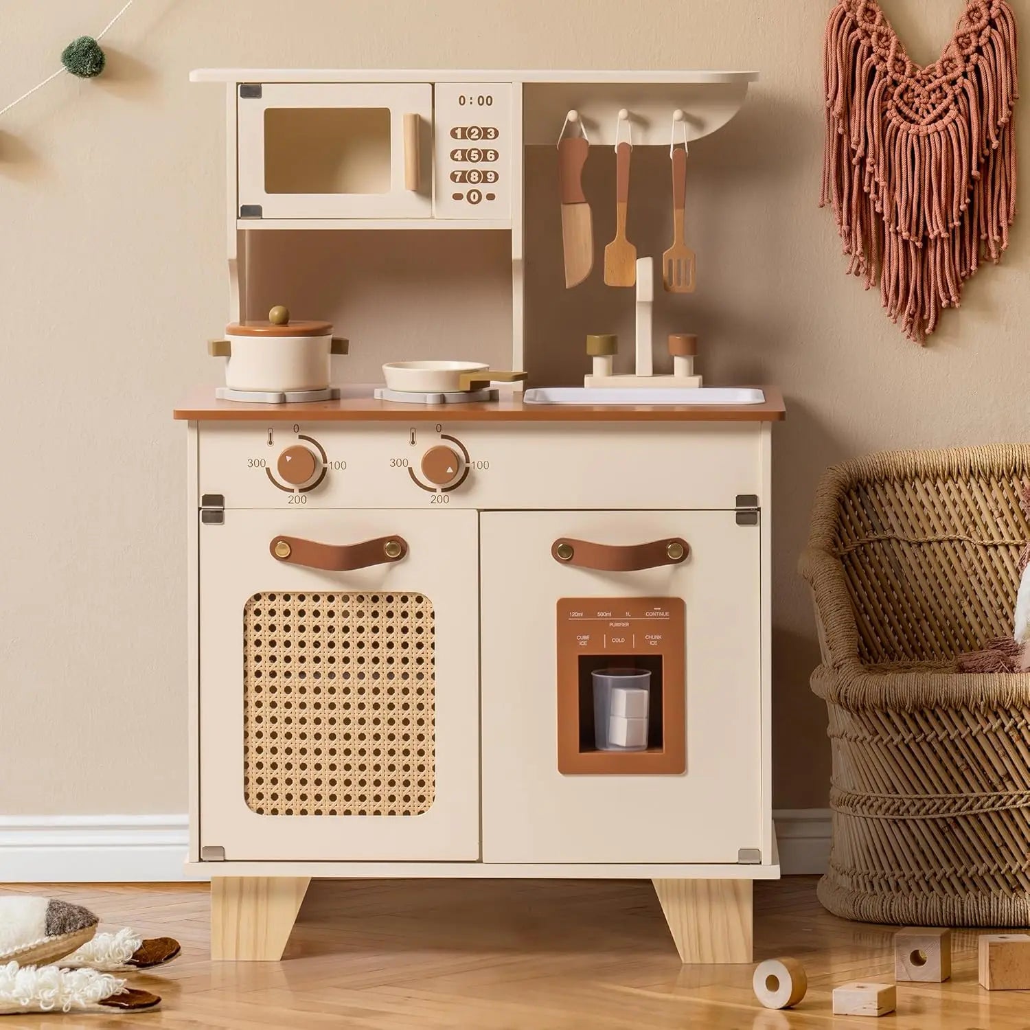 Children's play kitchen set with wooden cabinets and accessories on a wooden floor.