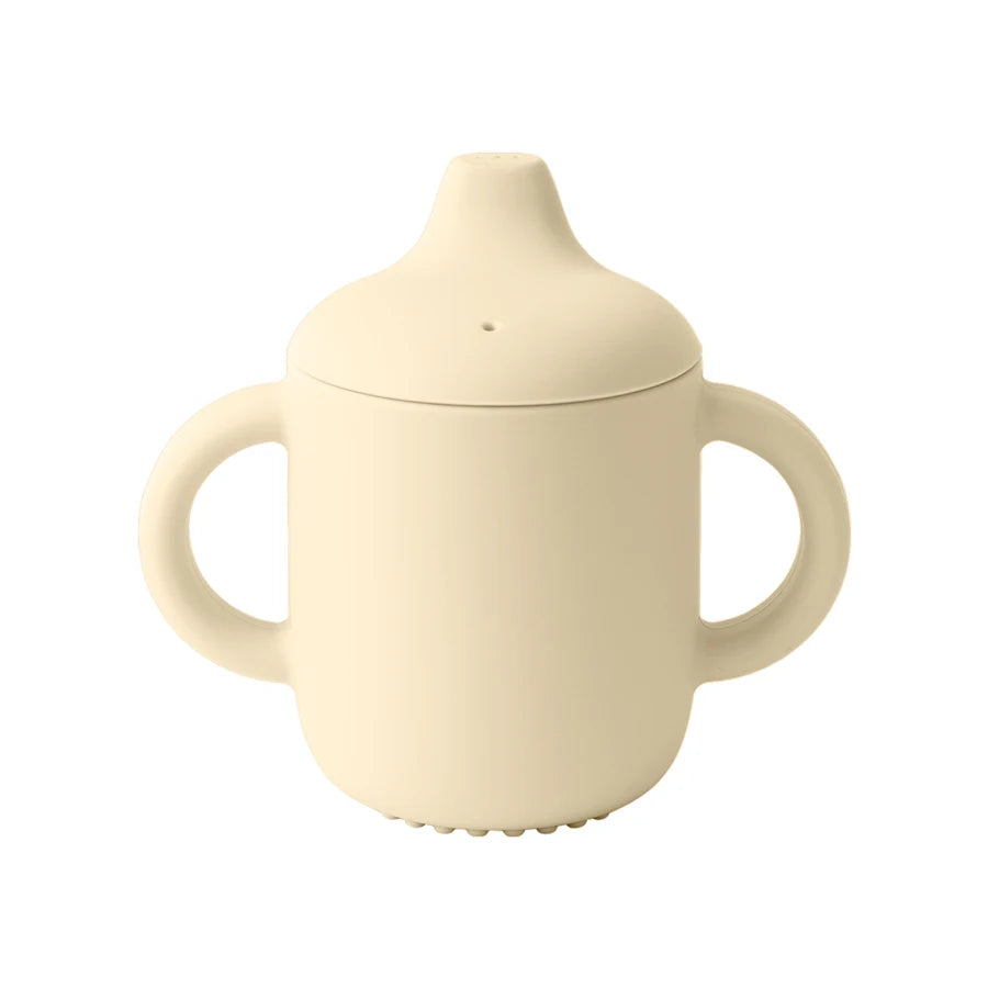 Cream-colored sippy cup with lid and handles on a white background