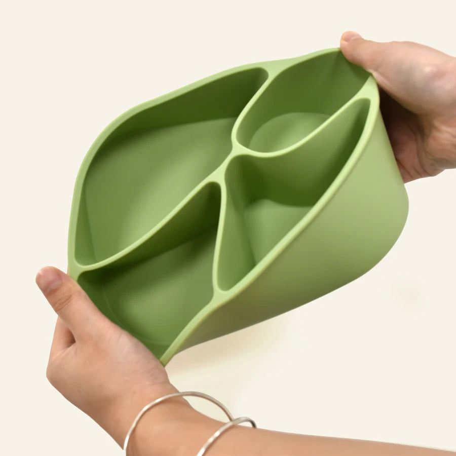 Flexible sage bento box bent in two hands