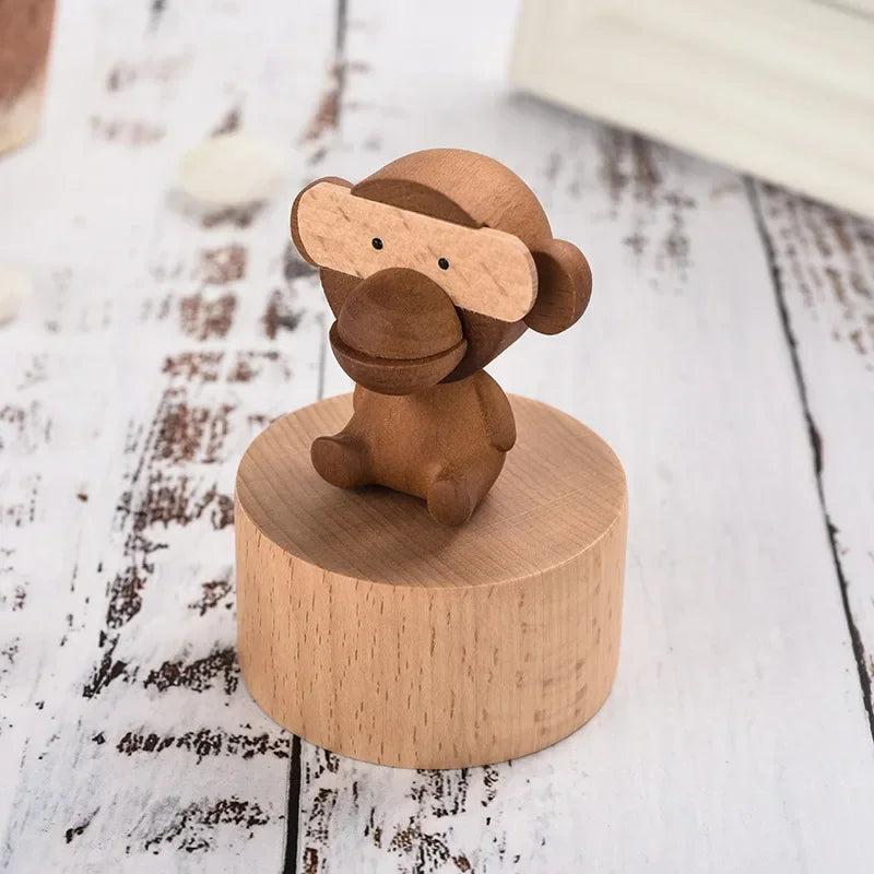 Wooden monkey figurine on a round wooden base against a rustic wooden background | Oliver & Company Montessori toys