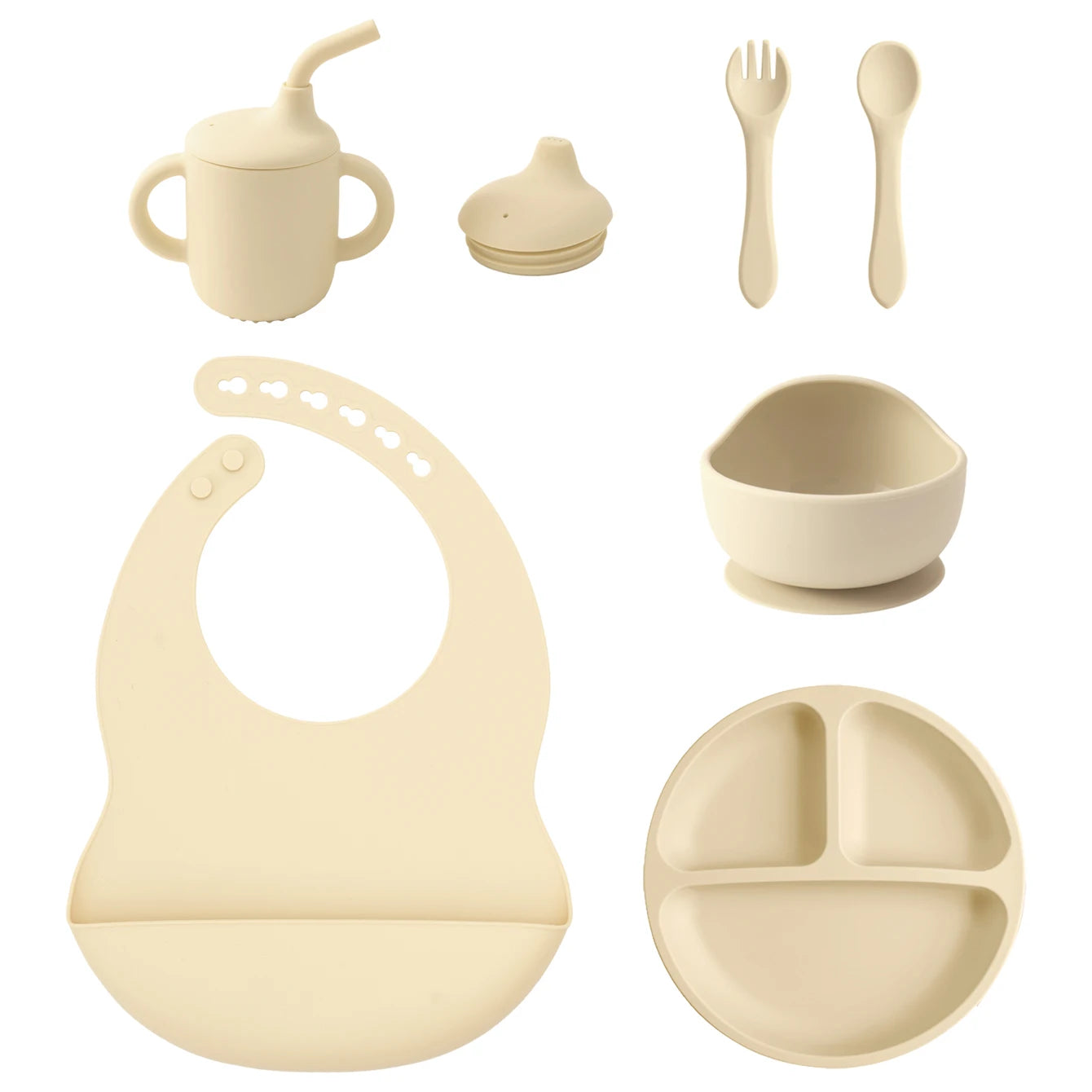 A set of baby feeding and drinking accessories in a warm cream/beige color, including a handled straw cup, a small bottle cap, a fork, a spoon, a suction bowl, a silicone bib, and a three-compartment plate, arranged on a plain white background.