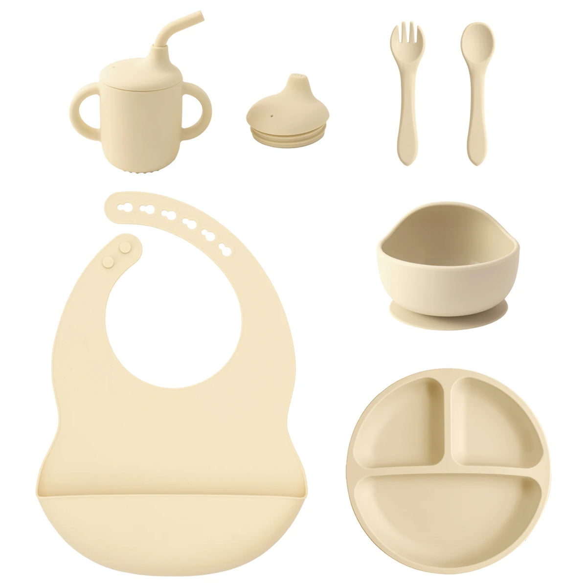 A set of baby feeding and drinking accessories in a warm cream/beige color, including a handled straw cup, a small bottle cap, a fork, a spoon, a suction bowl, a silicone bib, and a three-compartment plate, arranged on a plain white background.