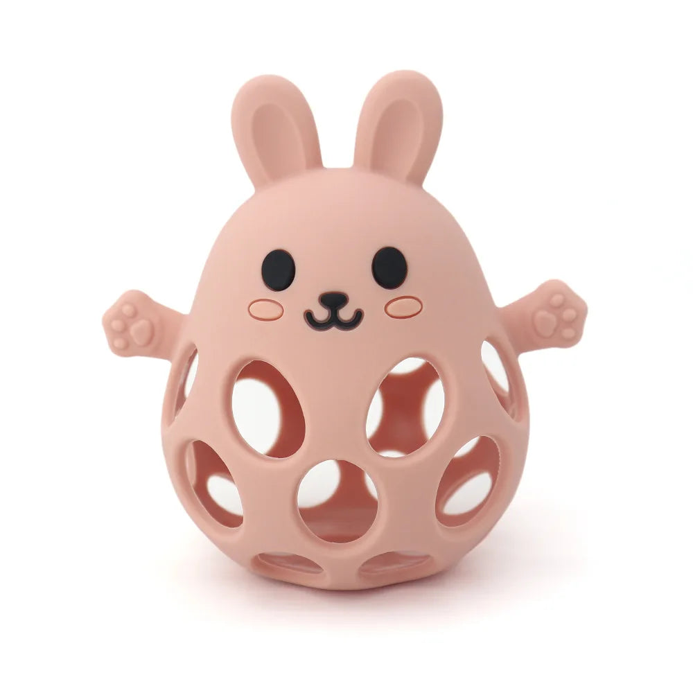 Pink rabbit-shaped toy with holes on a white background