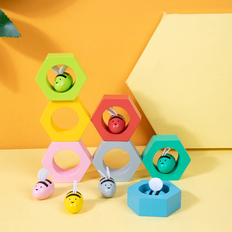 Colorful geometric baby toy set on a yellow background