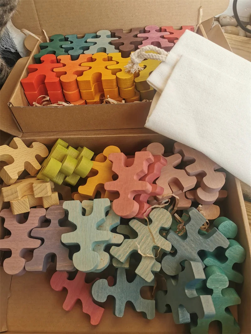Colorful wooden puzzle pieces in a cardboard box