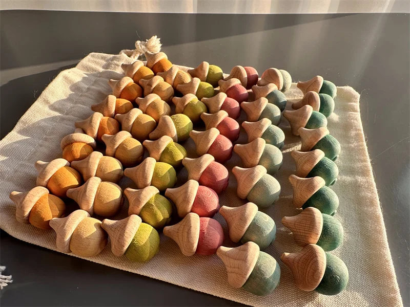 Colorful wooden acorn-shaped toys on a textured surface