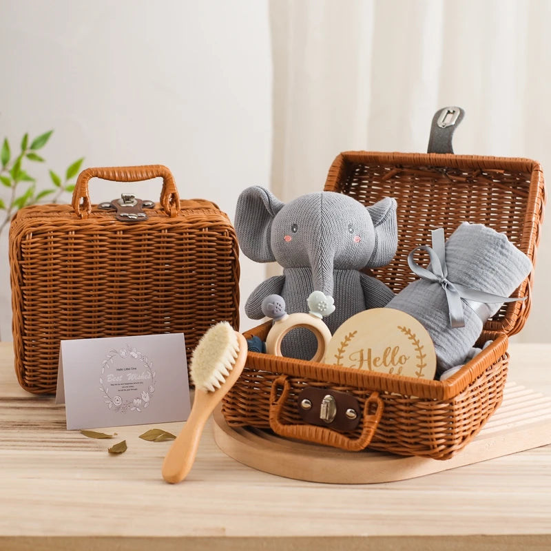 5-Piece Newborn Gift Set: Woven basket with a stuffed elephant, baby brush, teether, blanket, and milestone card, perfect for gifting new parents.