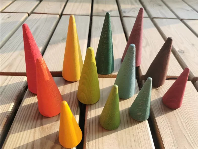 Colorful wooden cones on a wooden surface