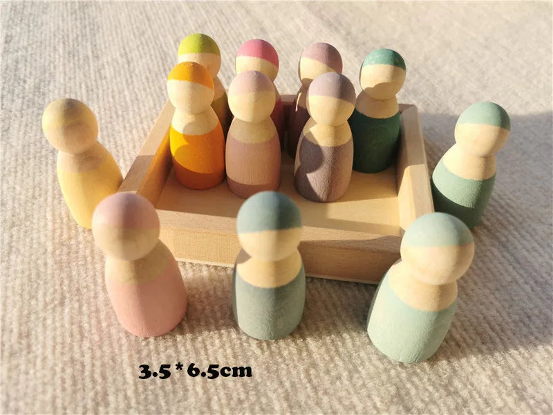 Colorful wooden peg dolls in a wooden box on a textured surface