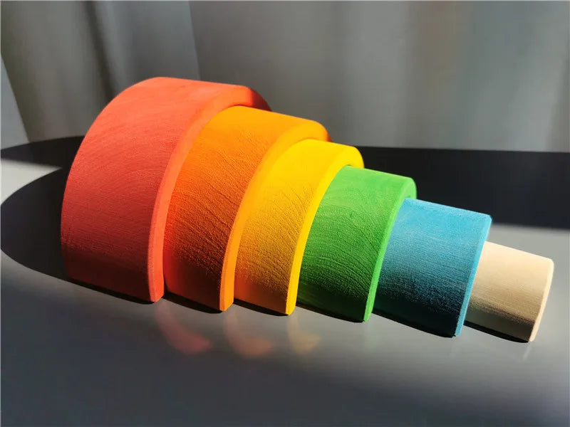 Set of colorful wooden arch on a dark surface with a neutral background