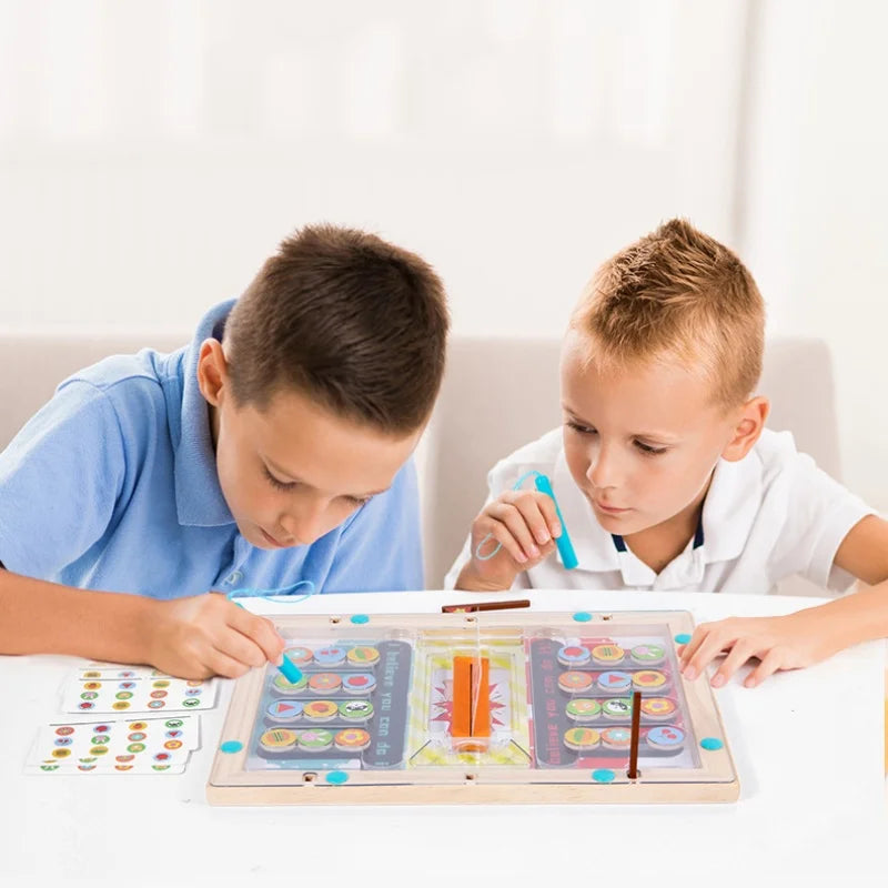 Two children playing with a educational board game on a white table.