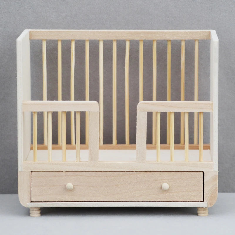 Wooden crib with a drawer on a gray background