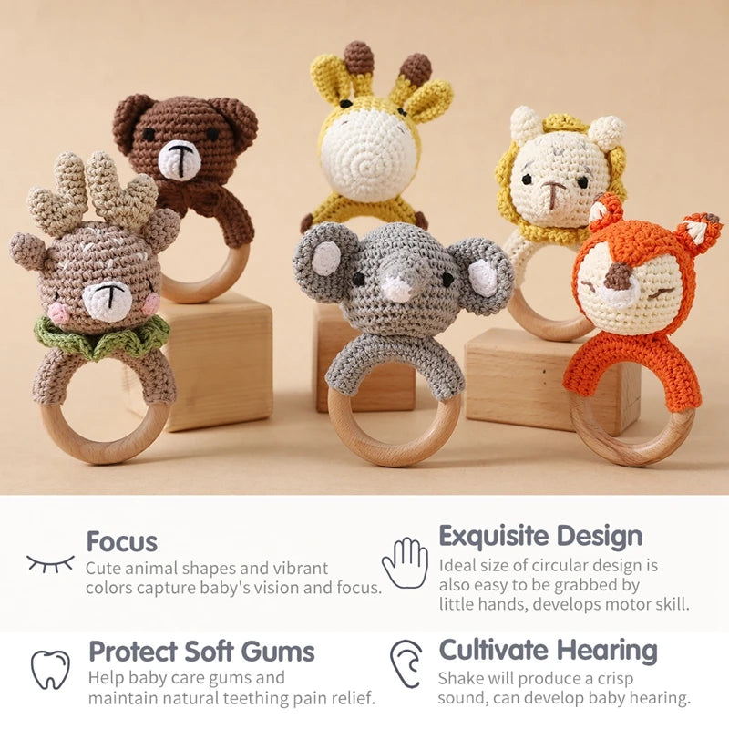 Set of six animal-themed wooden teething rings on a beige background