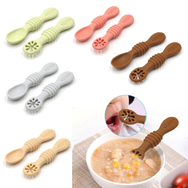 Set of colorful baby spoons with textured handles on a white background.