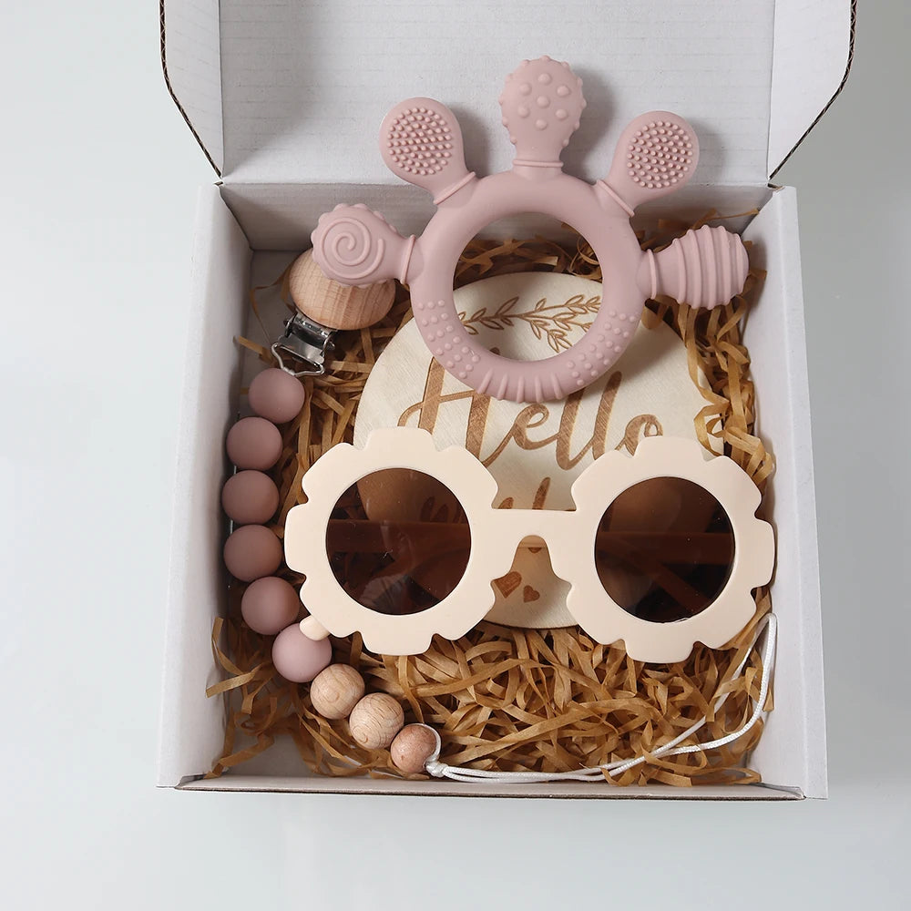 Baby teether and sunglasses set in a decorative box with 'Hello' text