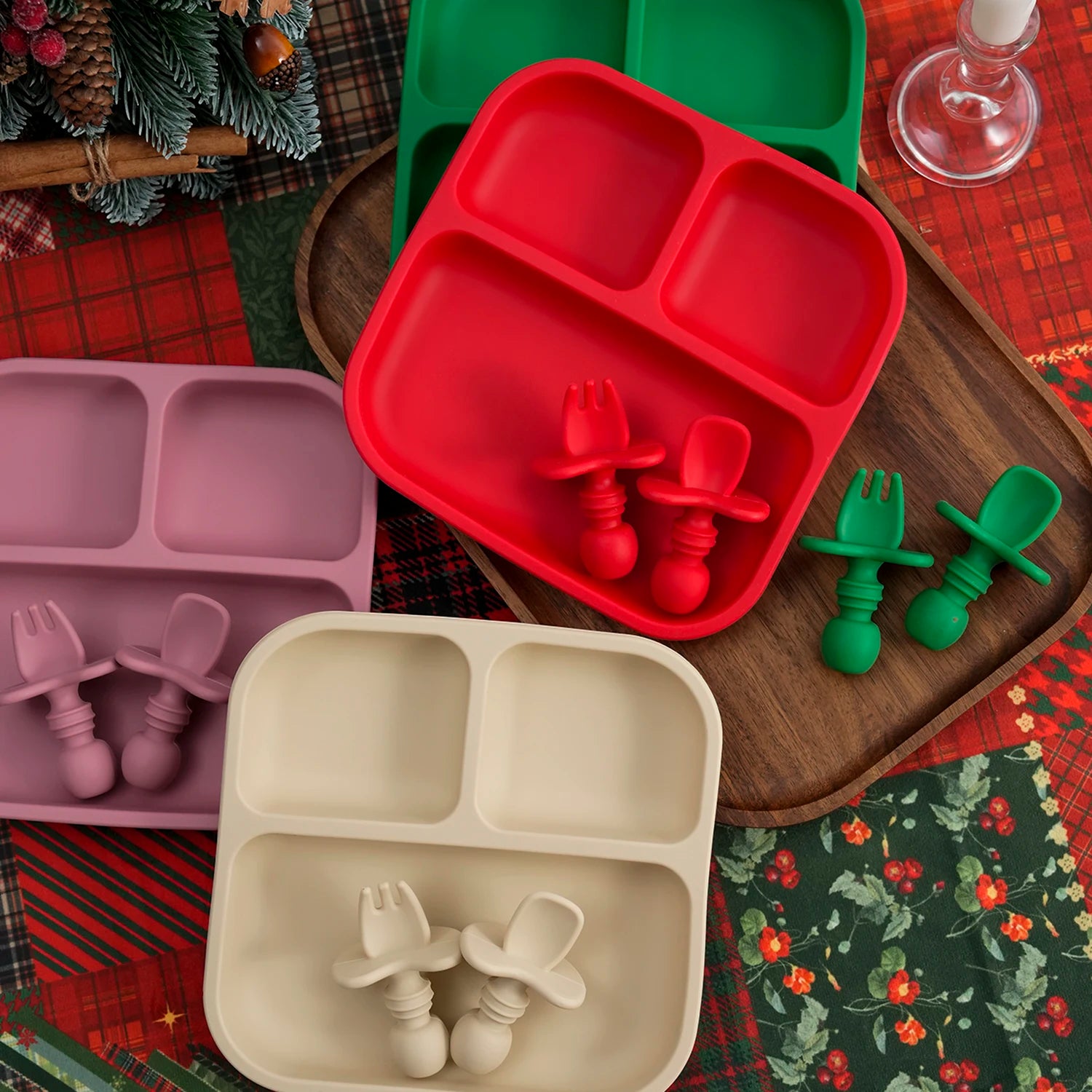Red and green silicone suction plate sets with pastel plates on Christmas plaid