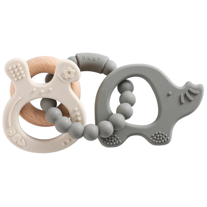 Two baby teething rings, one wooden and one silicone, on a white background.
