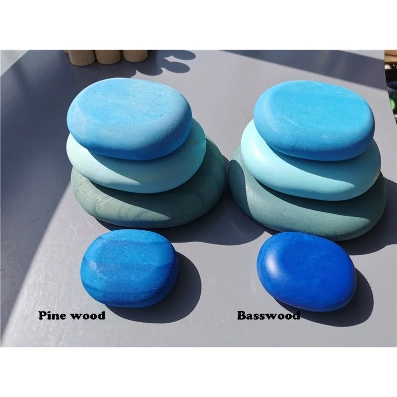 Stacks of blue stones labeled 'Pine wood' and 'Basswood' on a gray surface.