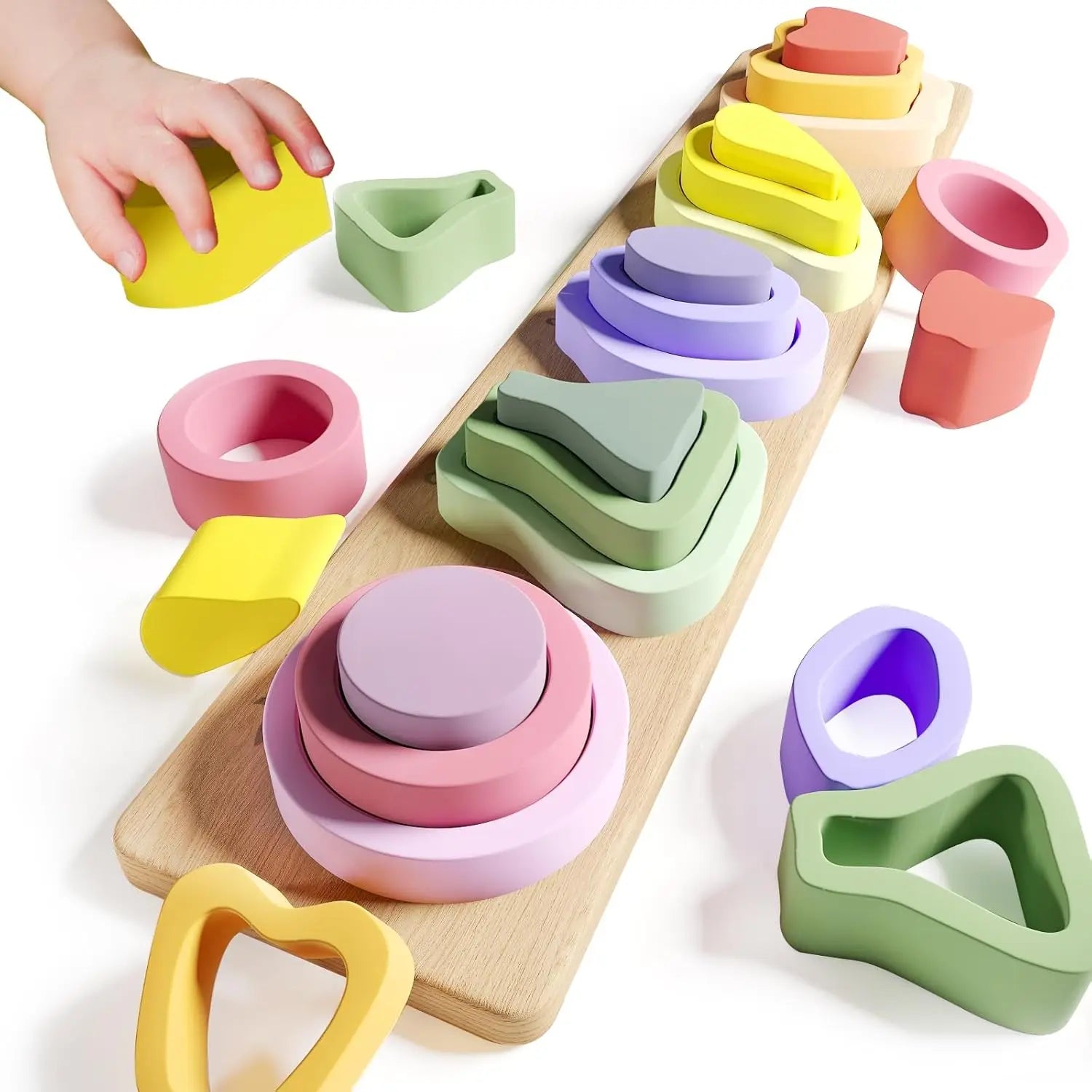 Colorful wooden shape sorting toy with a hand interacting with it on a white background