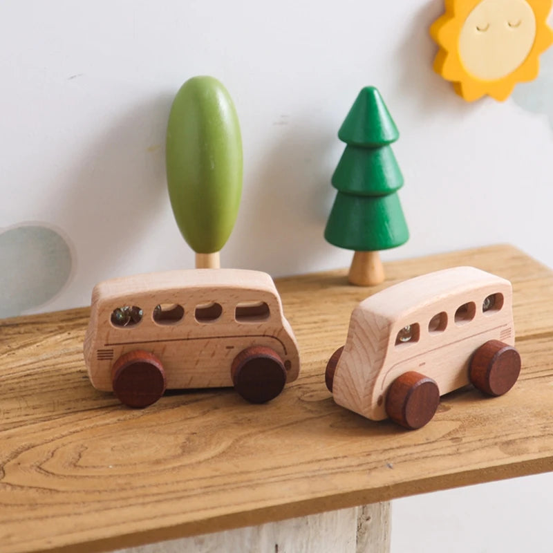 Baby Montessori Wooden Cartoon Bus made from beech wood with wheels, designed for imaginative play and developing motor skills, displayed on a table.