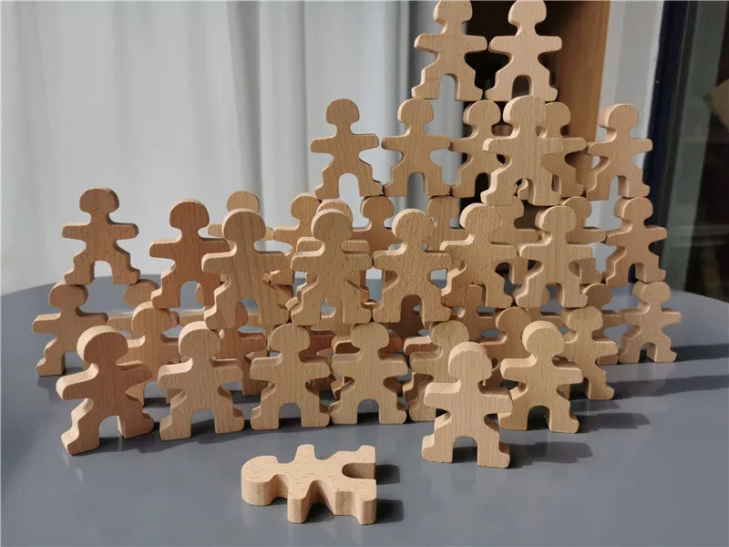 Stack of wooden figures on a gray surface with a blurred background